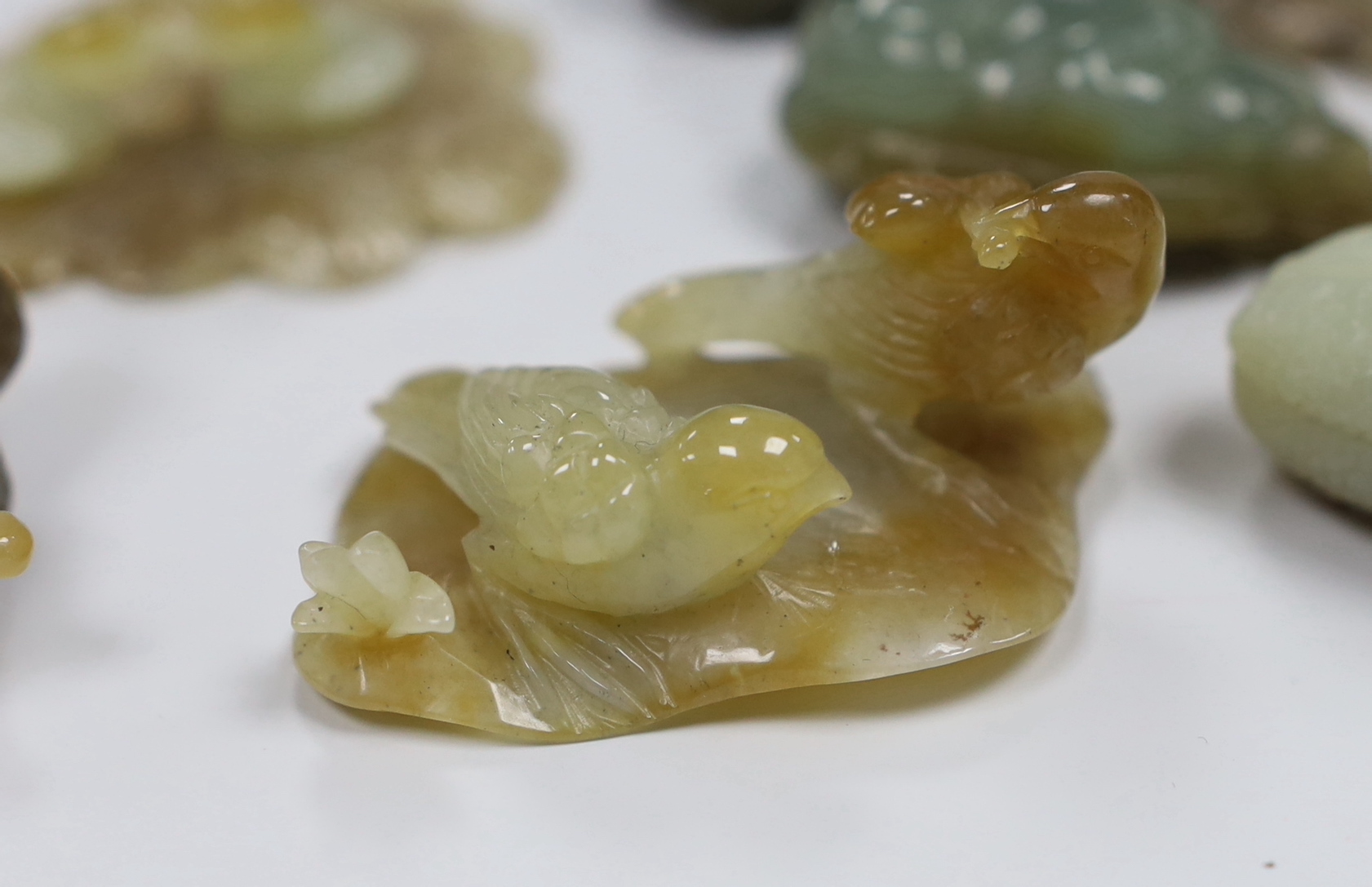 Nine Chinese jade carvings including ducks and caterpillars, the largest 9cm in length